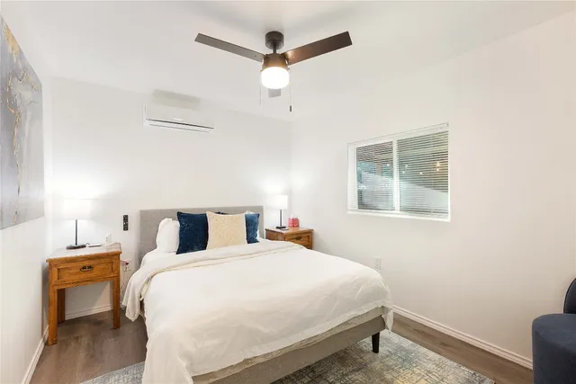 a bedroom with a bed and a chandelier