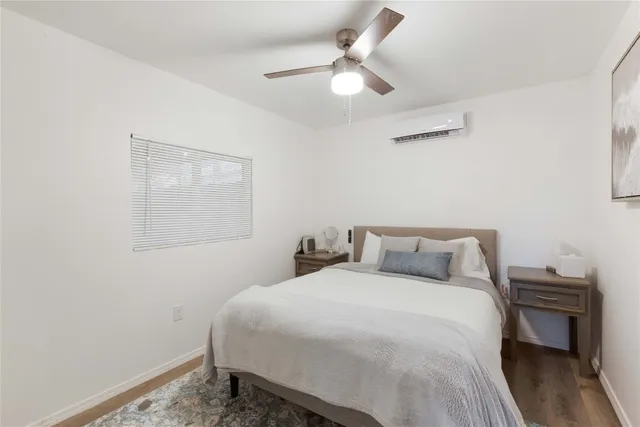 a kitchen with stainless steel appliances granite countertop a refrigerator a stove a sink and a dining table with wooden floor