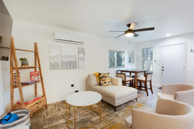 a kitchen with a refrigerator a stove and white cabinets with wooden floor