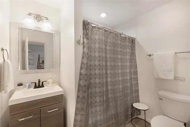 a bathroom with a sink a mirror and vanity