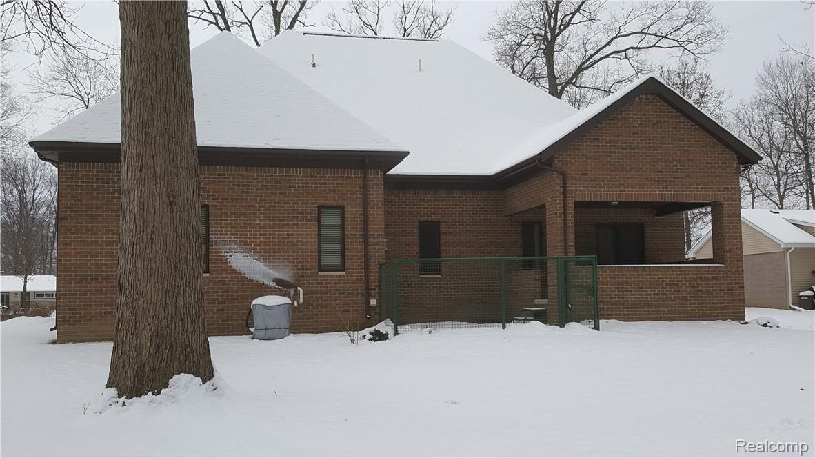 Rear elevation with covered porch and dog pen.