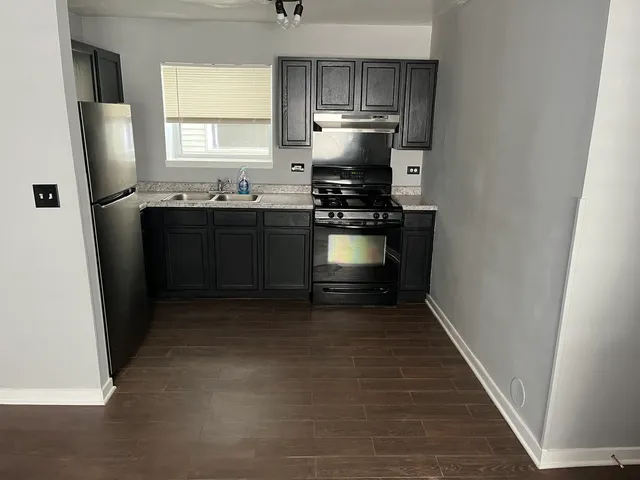 a kitchen with a refrigerator and a sink