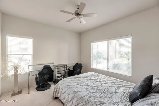 a bed room with two beds and a window