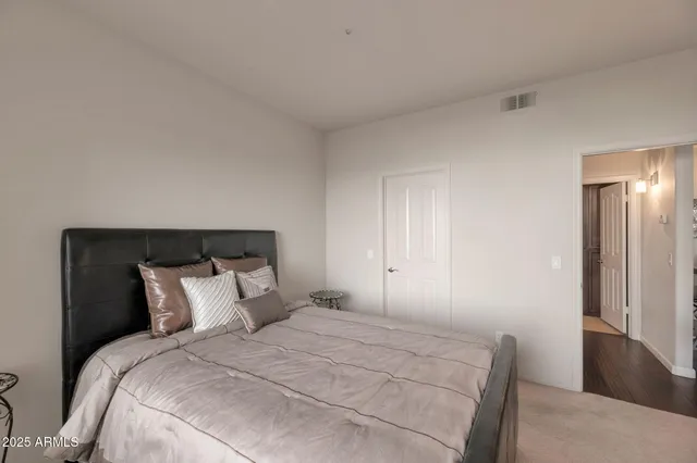 a bedroom with a bed and a lamp