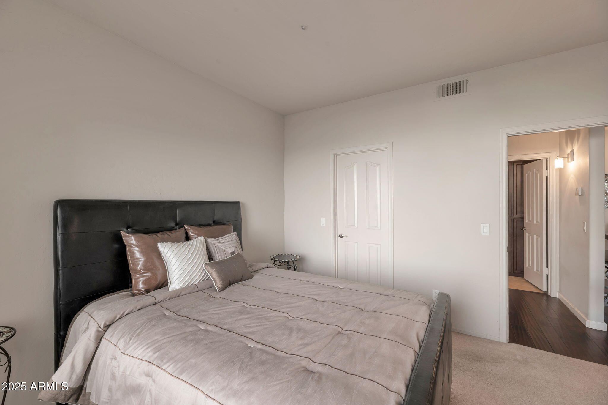 14145 North 92nd Street, Unit 1051 Scottsdale, AZ 85260 - Photo 16 of 21 a bedroom with a bed and a lamp