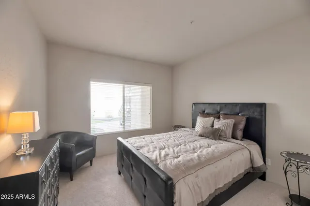 a bedroom with a bed and a lamp