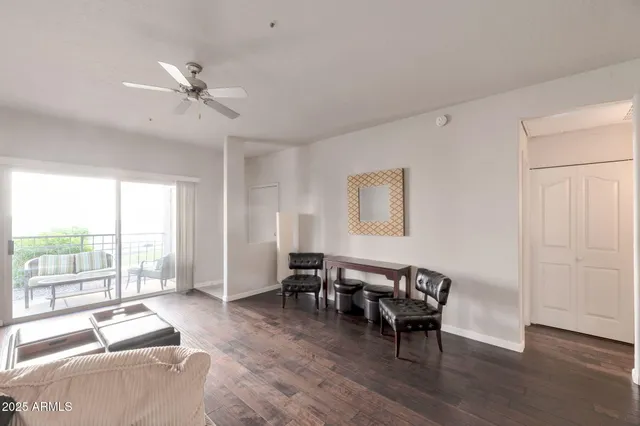 a living room with furniture and large windows