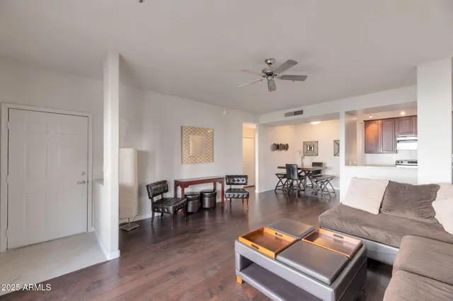 a living room with furniture a dining table with wooden floor