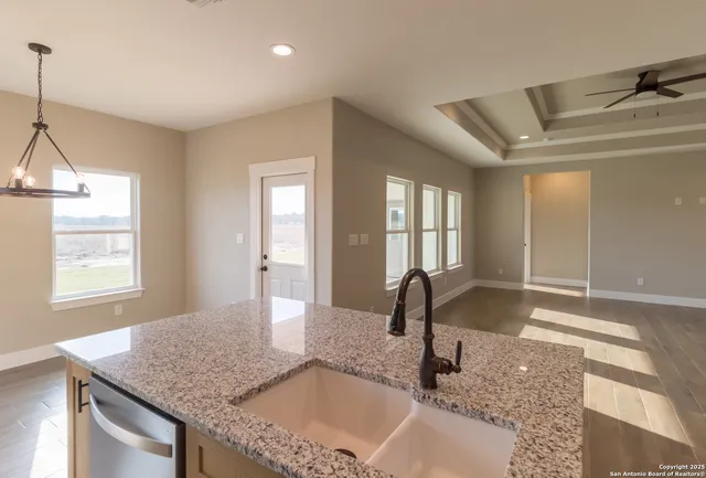 a kitchen with granite countertop a sink and a window