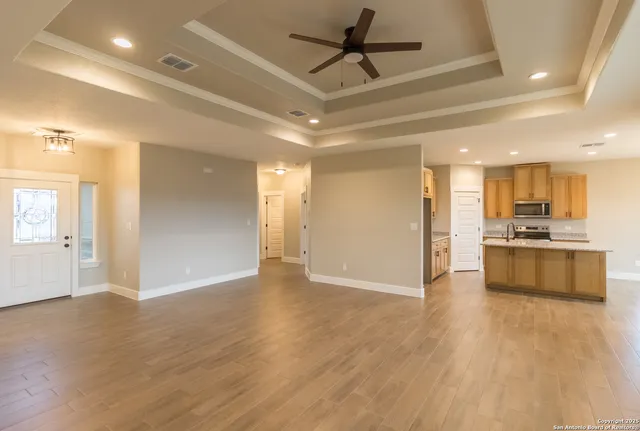 a view of kitchen with refrigerator and wooden floor
