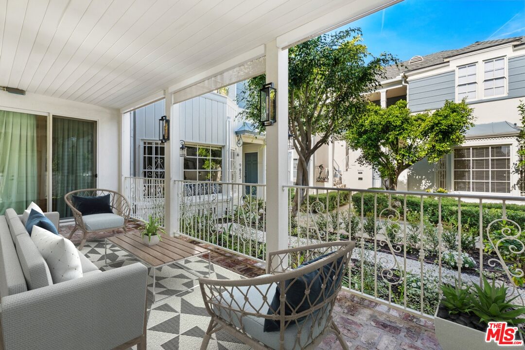 9683 West Olympic Boulevard Beverly Hills, CA 90212 - Photo 11 of 20 a balcony with furniture and a potted plant