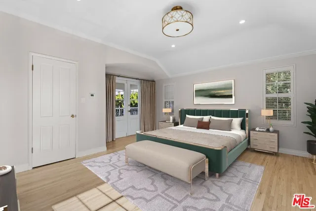 a bedroom with a large bed and a window