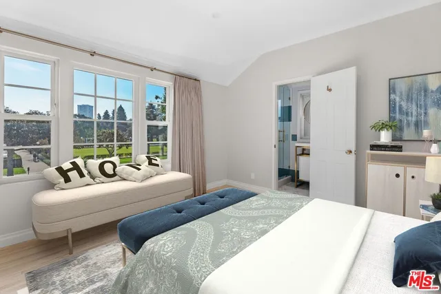 a bedroom with a large bed and a large window