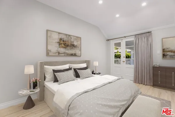 a bedroom with a bed and a painting on the wall