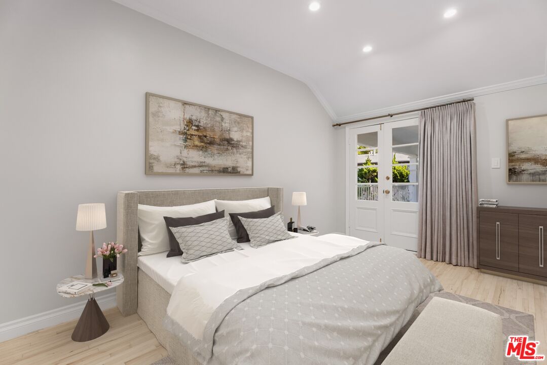 9683 West Olympic Boulevard Beverly Hills, CA 90212 - Photo 18 of 20 a bedroom with a bed and a painting on the wall