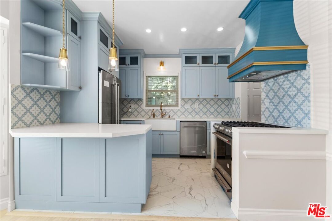 9683 West Olympic Boulevard Beverly Hills, CA 90212 - Photo 5 of 20 a kitchen with a sink cabinets and window