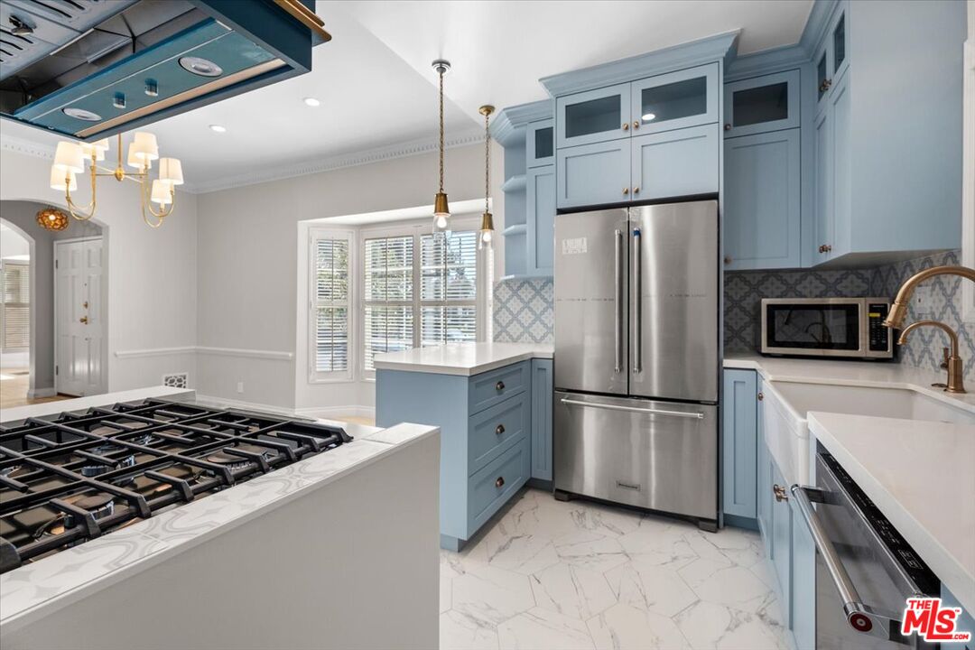 9683 West Olympic Boulevard Beverly Hills, CA 90212 - Photo 6 of 20 a kitchen with a refrigerator and a stove