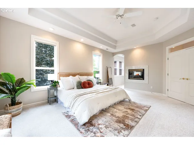 a spacious bedroom with a large bed and potted plant