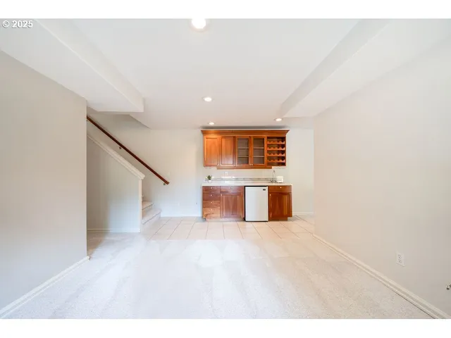 a view of a big room with wooden floor and windows