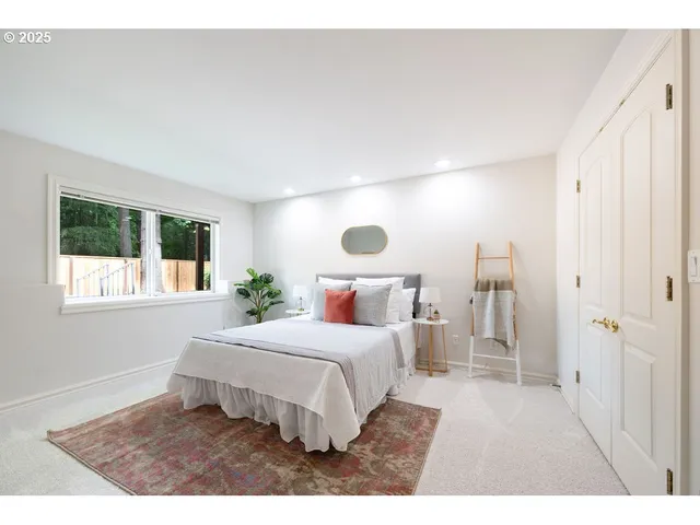 a bedroom with a large bed and a window