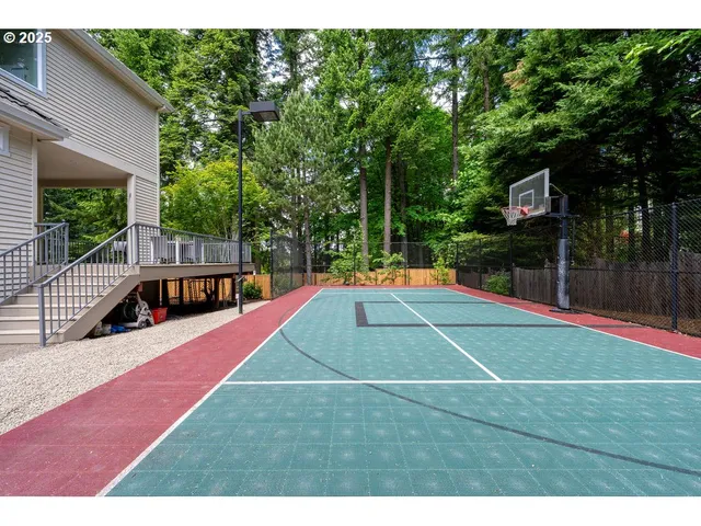 a view of an house with backyard and a tree