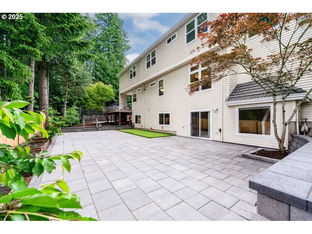 a view of a white house with a yard