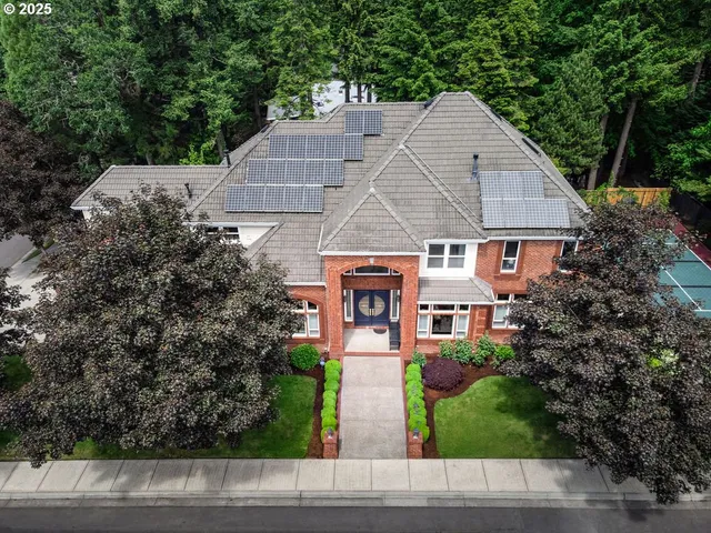 an aerial view of a house with a yard and outdoor seating