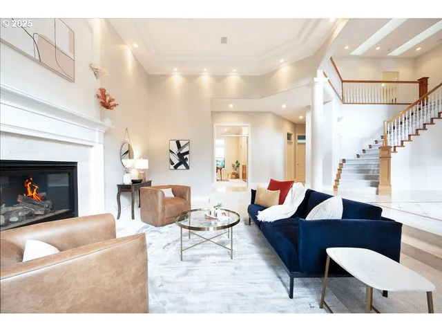 a living room with furniture a table and a fireplace