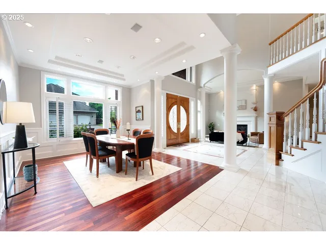 a view of a dining room with furniture a rug and wooden floor