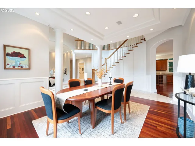 a dining room with furniture and wooden floor