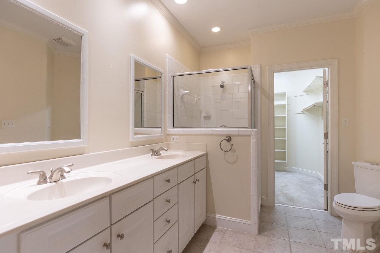 7382 Fontana Ridge Lane Raleigh, NC 27613 - Photo 17 of 30 a bathroom with a granite countertop sink a toilet and shower