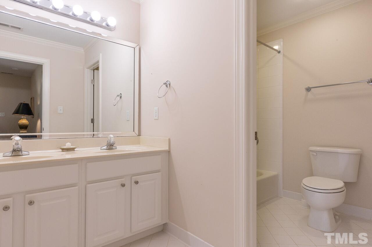 7382 Fontana Ridge Lane Raleigh, NC 27613 - Photo 21 of 30 a bathroom with a toilet a sink and a mirror