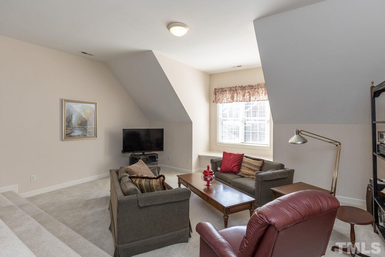 7382 Fontana Ridge Lane Raleigh, NC 27613 - Photo 24 of 30 a living room with furniture and a flat screen tv