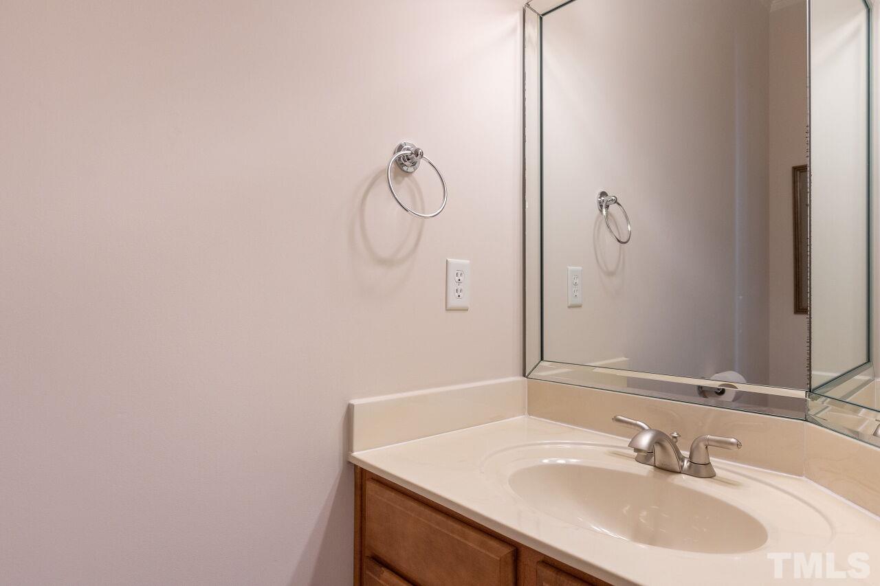 7382 Fontana Ridge Lane Raleigh, NC 27613 - Photo 7 of 30 a bathroom with a sink and a mirror