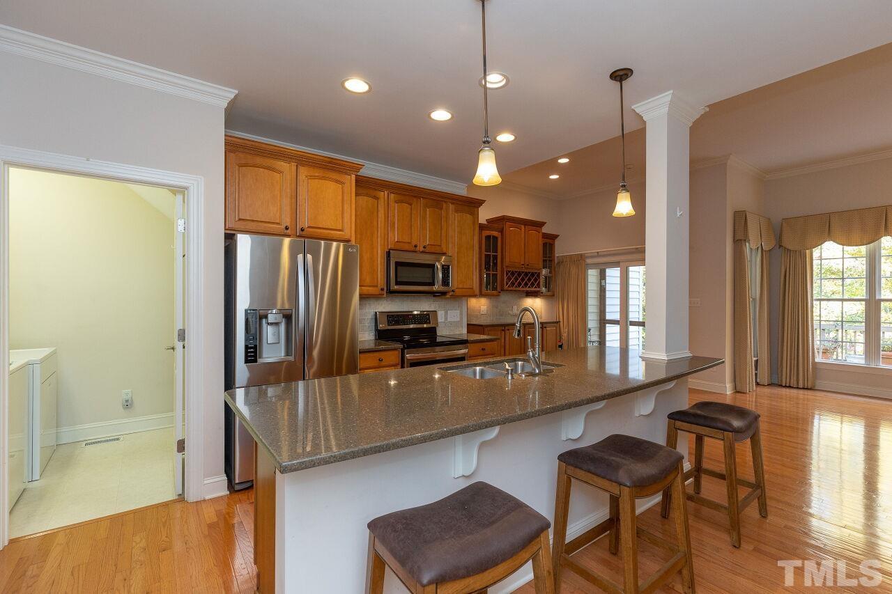 7382 Fontana Ridge Lane Raleigh, NC 27613 - Photo 8 of 30 a kitchen with counter top space cabinets and stainless steel appliances