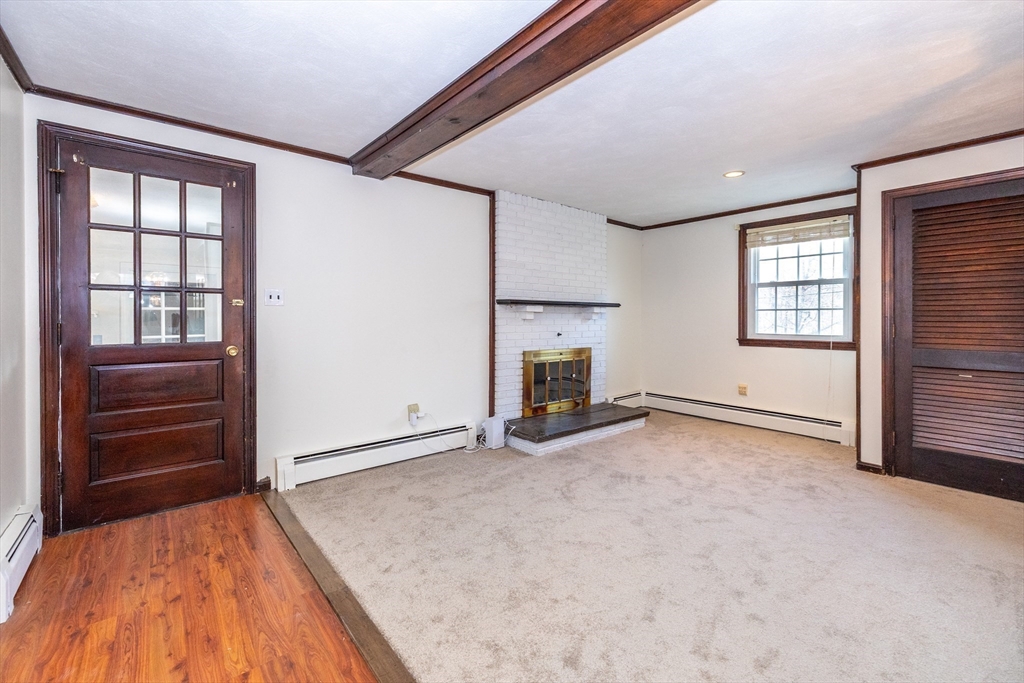 97 Kendall Road Tewksbury, MA 01876 - Photo 16 of 32 a view of an empty room with a fireplace and a window