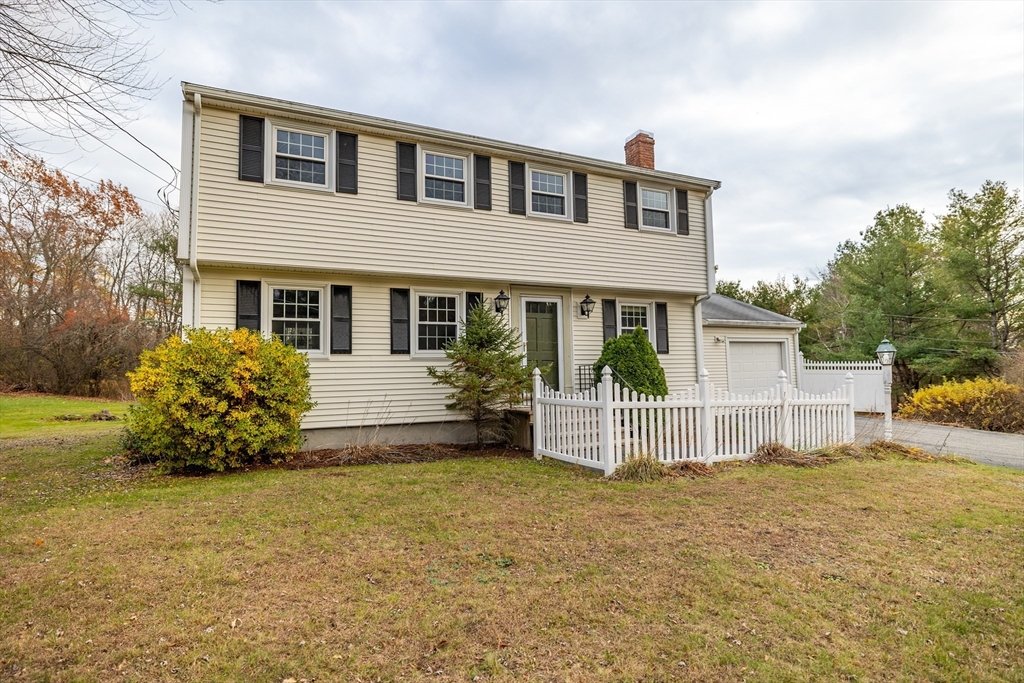 97 Kendall Road Tewksbury, MA 01876 - Photo 2 of 32 a front view of a house with a yard