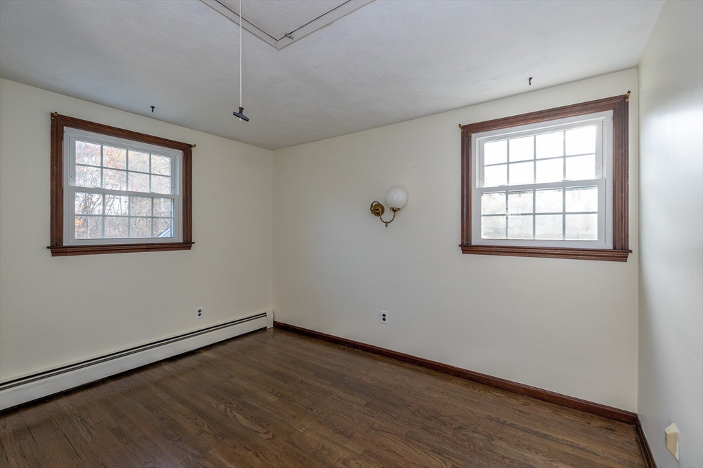 97 Kendall Road Tewksbury, MA 01876 - Photo 23 of 32 an empty room with wooden floor and windows