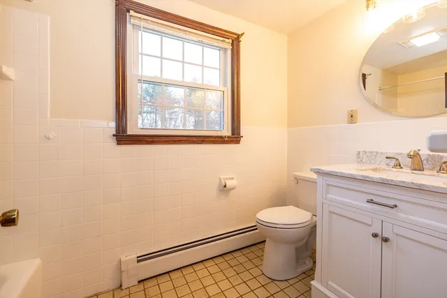 a bathroom with a toilet a sink and a mirror