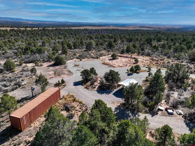 a view of a yard with wooden fence