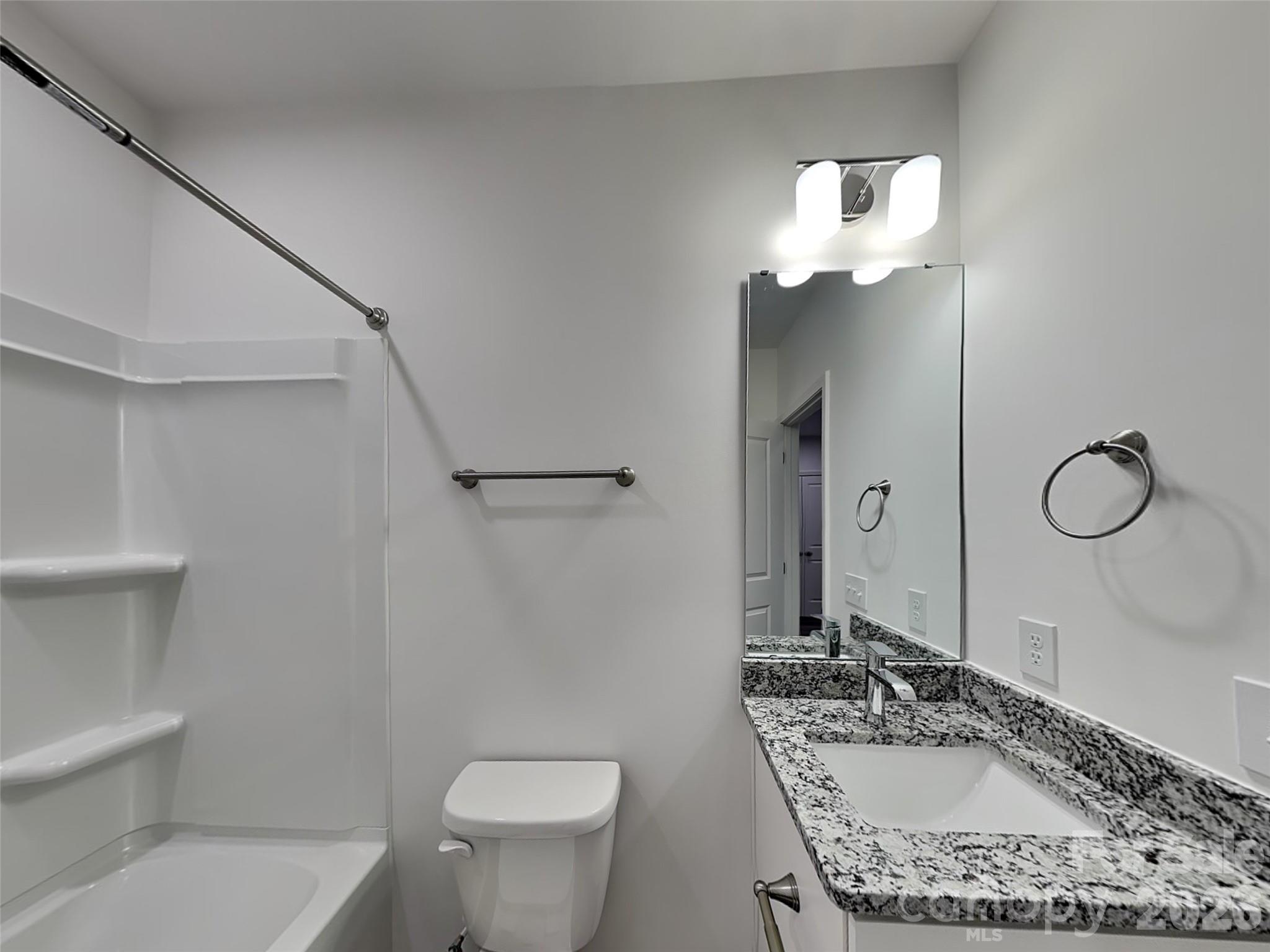 481 Hager Lake Road Mooresville, NC 28115 - Photo 18 of 23 a bathroom with a granite countertop sink a toilet and a mirror