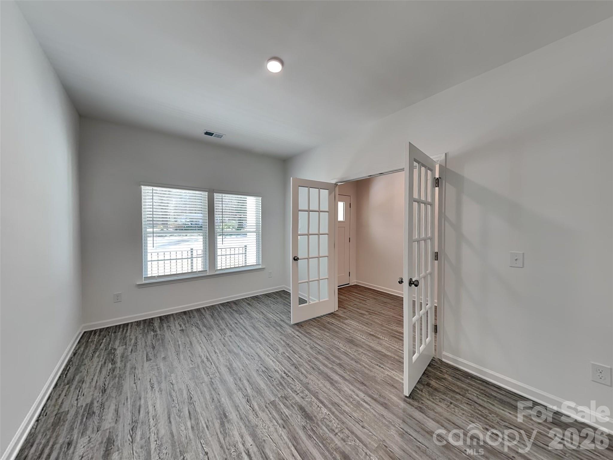 481 Hager Lake Road Mooresville, NC 28115 - Photo 19 of 23 wooden floor in an empty room with a window