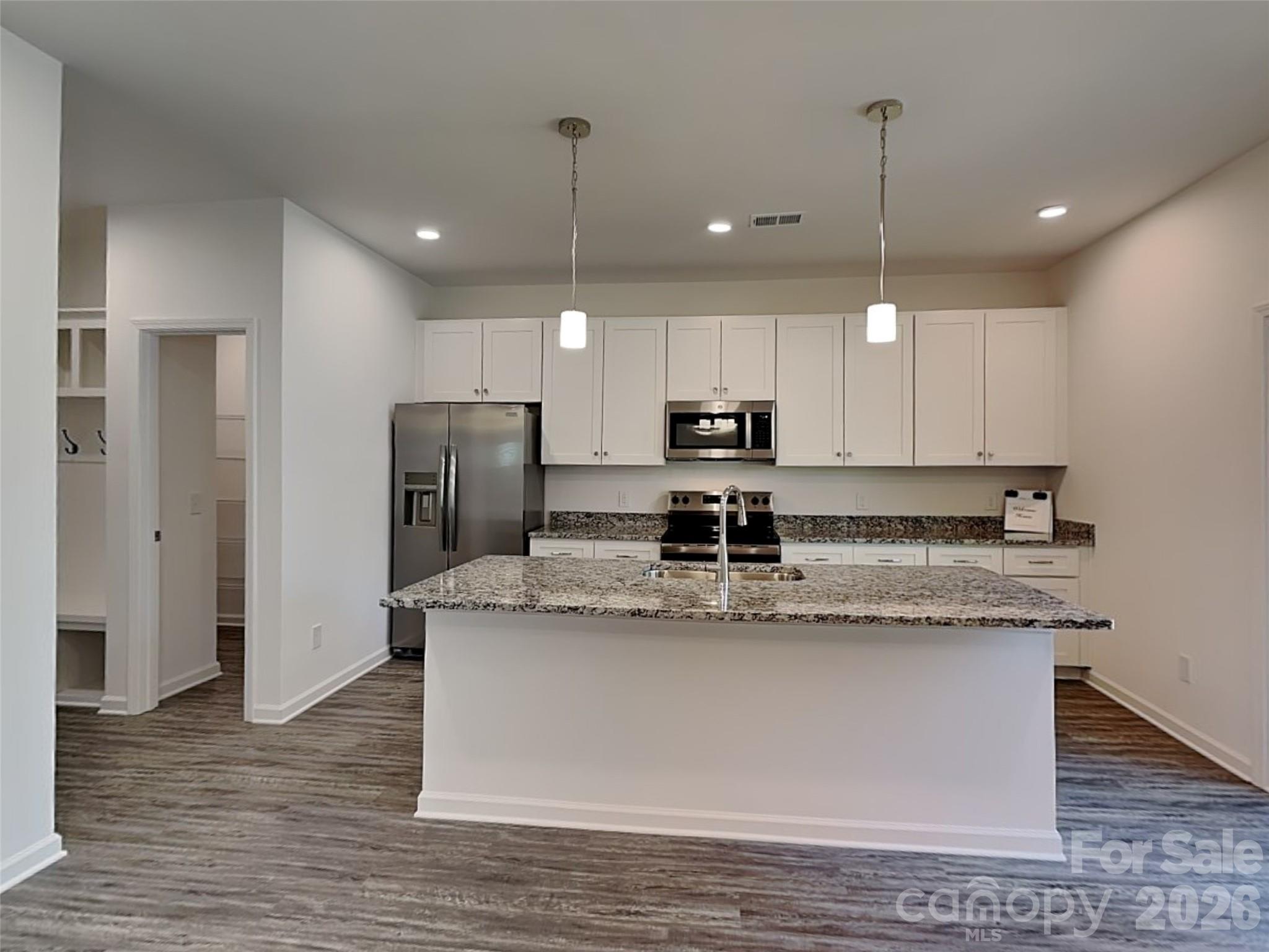 481 Hager Lake Road Mooresville, NC 28115 - Photo 2 of 23 a kitchen with stainless steel appliances granite countertop a sink a refrigerator a microwave and island