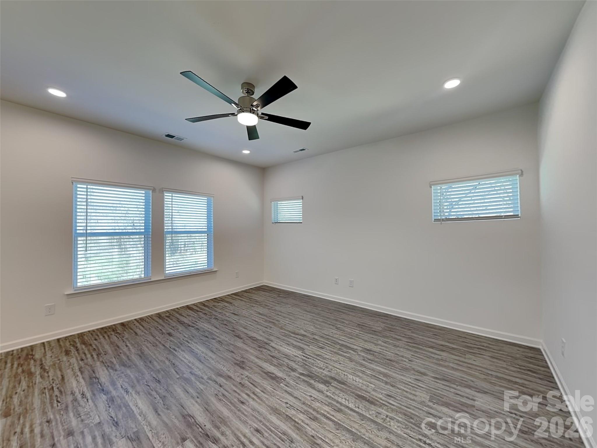 481 Hager Lake Road Mooresville, NC 28115 - Photo 5 of 23 a view of an empty room with a window and wooden floor