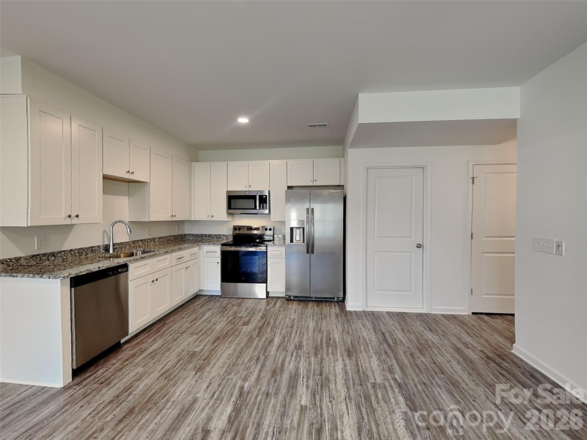 481 Hager Lake Road Mooresville, NC 28115 - Photo 6 of 23 a large kitchen with granite countertop a large counter top space stainless steel appliances and cabinets