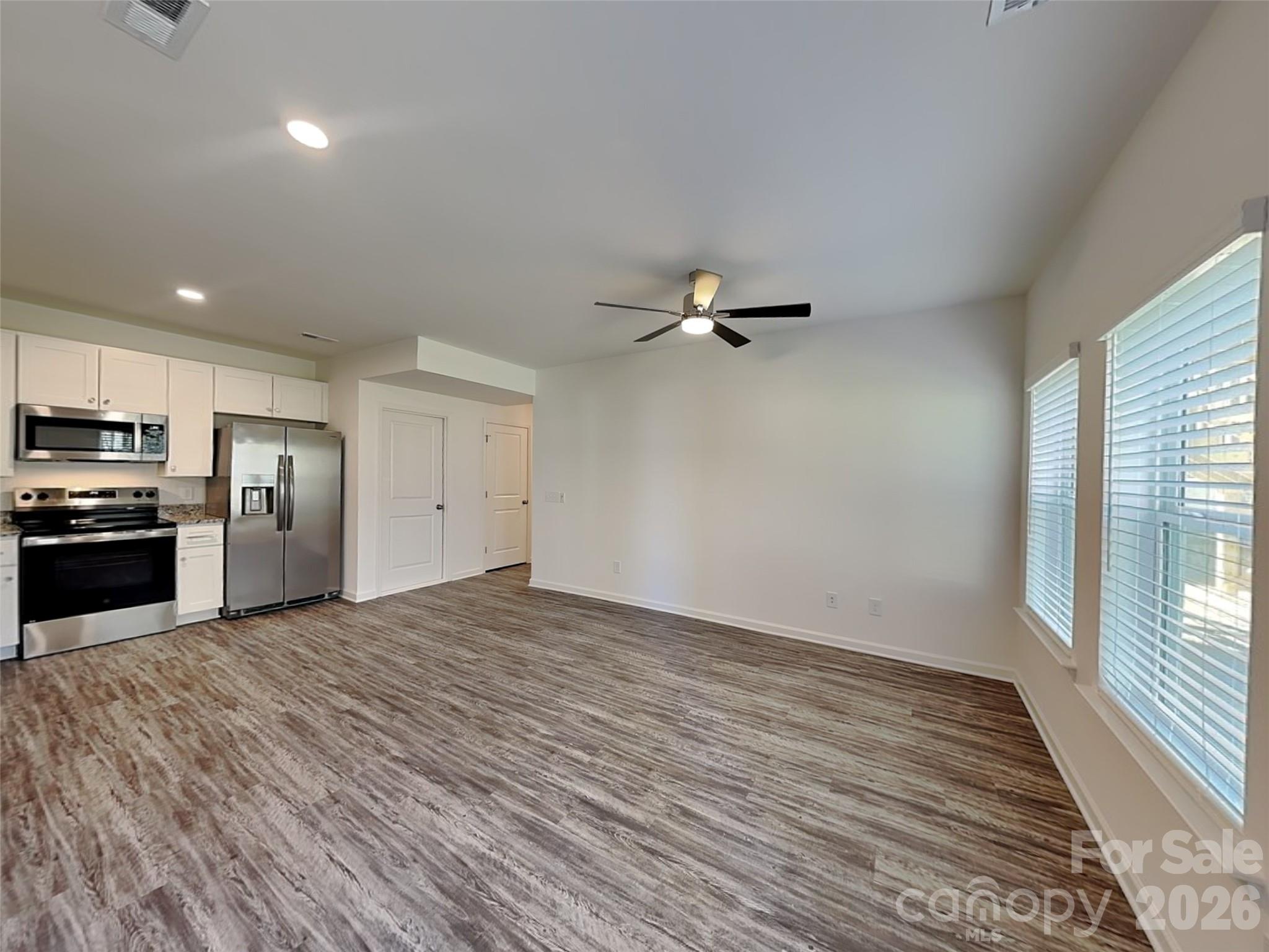 481 Hager Lake Road Mooresville, NC 28115 - Photo 7 of 23 a view of a kitchen with a sink and dishwasher a refrigerator with wooden floor