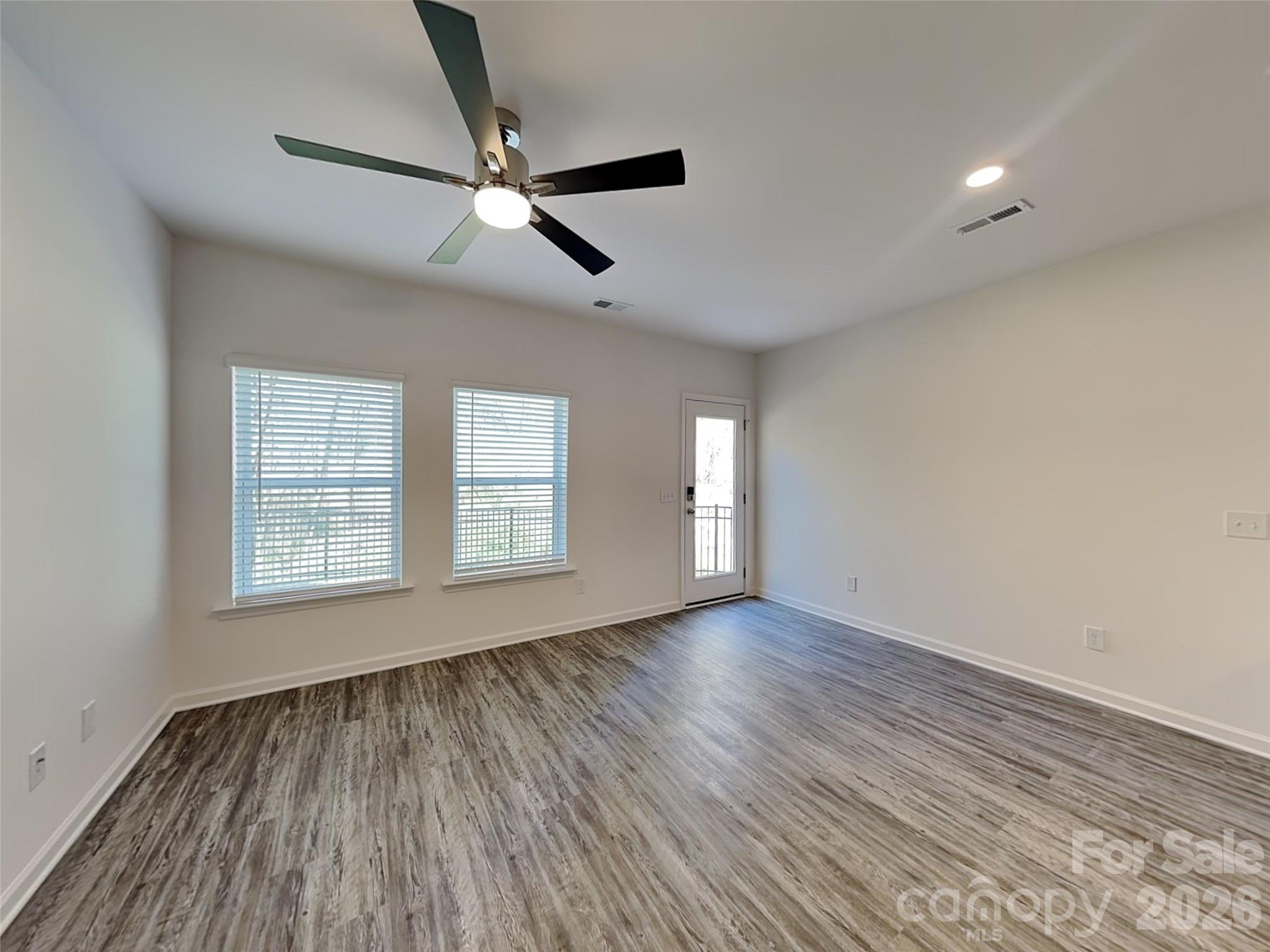 481 Hager Lake Road Mooresville, NC 28115 - Photo 8 of 23 a view of an empty room with a window and wooden floor