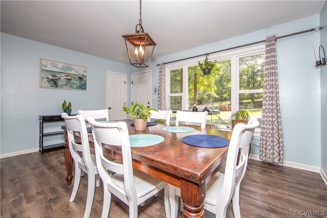 16206 Rowlett Road Chesterfield, VA 23838 - Photo 3 of 32 a dining room with furniture a chandelier and wooden floor