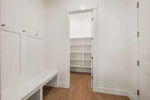 a view of a room with wooden floor and closet
