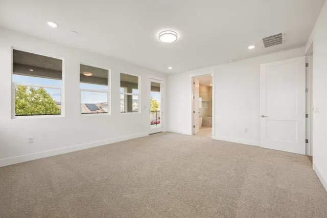 an empty room with windows and closet